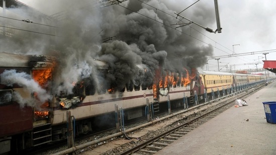 Protester set ablaze Farakka Express train at Danapur Railway Station on Friday. (Photo by Santosh Kumar /Hindustan Times)