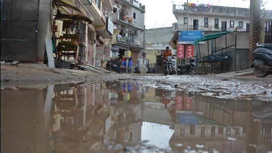 A dug-up road filled with rain water in Behlana, Chandigarh. (HT Photo)