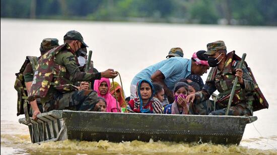 Army personnel evacuate the flood-affected victims after heavy rainfall, in the Hojai district of Assam on Saturday. (ANI)