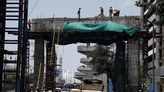Workers are seen at a segment at construction site.(Rahul Raut/HT File Photo)