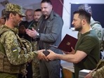 In this photo provided by the Ukrainian Presidential Press Office, Ukrainian President Volodymyr Zelenskyy, right, awards a serviceman as he visits the war-hit Mykolaiv region. (AP for representation) In this photo provided by the Ukrainian Presidential Press Office, Ukrainian President Volodymyr Zelenskyy, right, awards a serviceman as he visits the war-hit Mykolaiv region. (AP for representation)