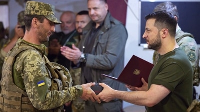 In this photo provided by the Ukrainian Presidential Press Office, Ukrainian President Volodymyr Zelenskyy, right, awards a serviceman as he visits the war-hit Mykolaiv region. (AP for representation) In this photo provided by the Ukrainian Presidential Press Office, Ukrainian President Volodymyr Zelenskyy, right, awards a serviceman as he visits the war-hit Mykolaiv region. (AP for representation)