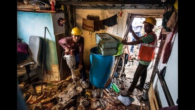 Two persons were injured after a stone slab crashed inside a hut from an adjoining hill at New Bharat Nagar, Chembur in Mumbai, India, on Sunday (Satish Bate/ Hindustan Times)