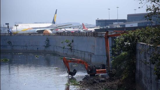 As part of pre-monsoon desilting, BMC workers clean up the Mithi River close to the international airport. (Vijay Bate/HT Photo) As part of pre-monsoon desilting, BMC workers clean up the Mithi River close to the international airport. (Vijay Bate/HT Photo)
