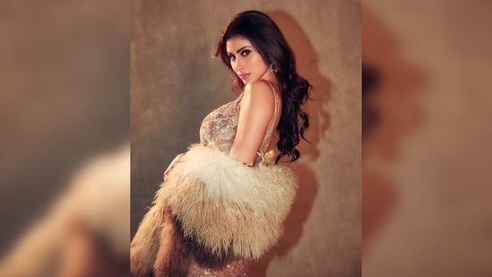 Mouni Roy paired the jaw-dropping gown with a fur wrap cape and dazzling open toe stilettoes.(Instagram/@imouniroy)