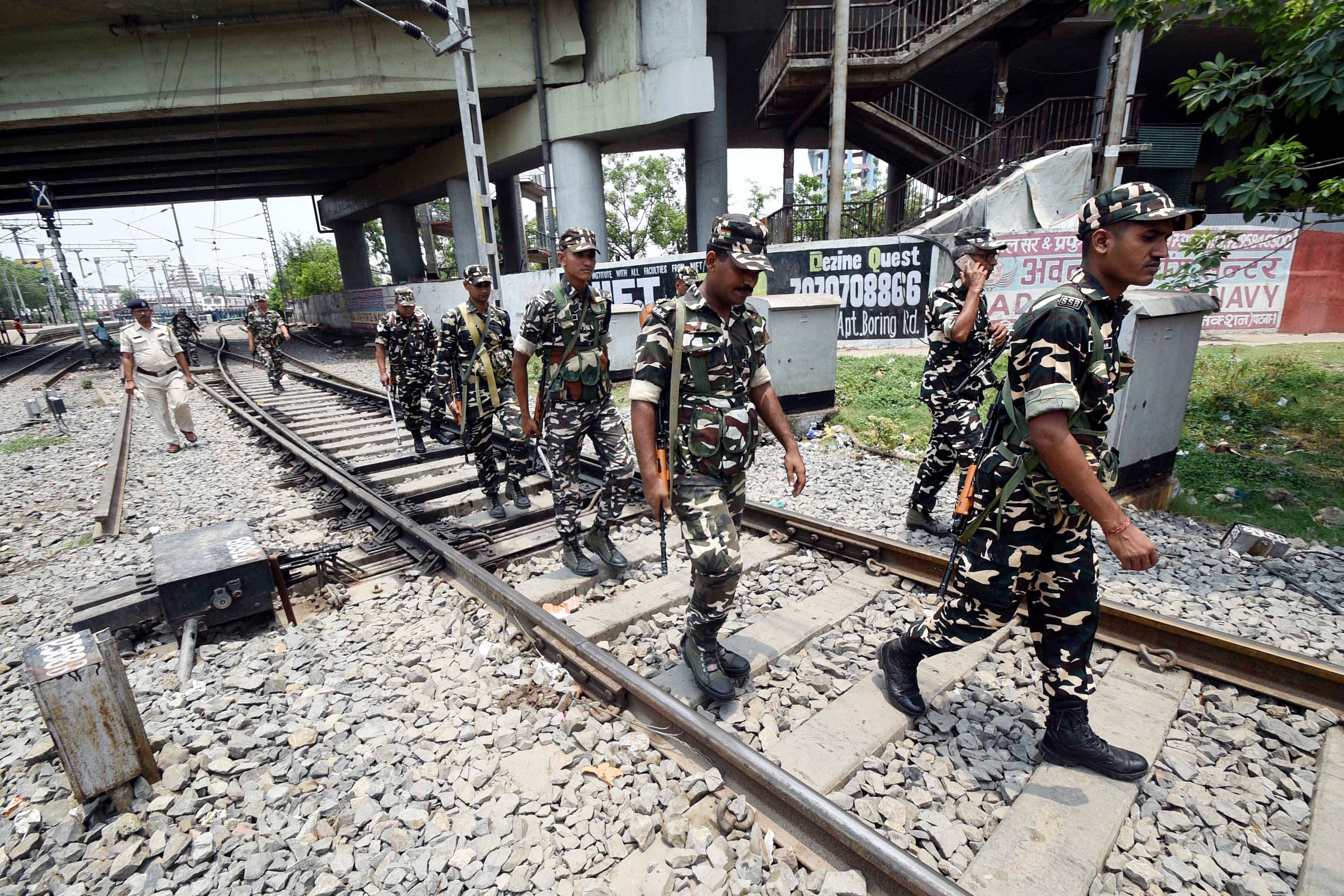 Paramilitary personnel patrol along the railway tracks as several trains were canceled in view of the ongoing Agnipath agitations, in Patna on Sunday. (ANI) Paramilitary personnel patrol along the railway tracks as several trains were canceled in view of the ongoing Agnipath agitations, in Patna on Sunday. (ANI)