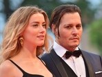 (FILES) In this photo taken on September 04, 2015 US actor Johnny Depp and his wife US actress Amber Heard arrive for screening of Black Mass at the 72nd Venice International Film Festival. A US jury on June 1, 2022 found both of them defamed each other, but sided far more strongly with Johnny. (Photo by GIUSEPPE CACACE / AFP)(AFP)