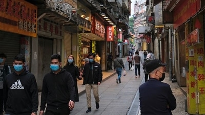 People wear masks as they walk near Ruins of St. Paul’s, following the coronavirus outbreak in Macau, China. (REUTERS)
