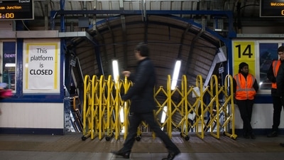A passenger walks past a closed entrance to a platform used by Southern Rail at Clapham Junction station in London on during a Southern Rail drivers strike. - Strikes. (AFP) A passenger walks past a closed entrance to a platform used by Southern Rail at Clapham Junction station in London on during a Southern Rail drivers strike. - Strikes. (AFP)