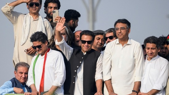 Ousted Pakistan's prime minister Imran Khan (C) waves at his party supporters during a rally in Islamabad. (AFP)