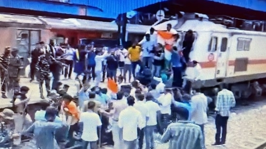 Youth Congress workers protesting in front of a train at Delhi's Shivaji Bridge railway station.&nbsp;