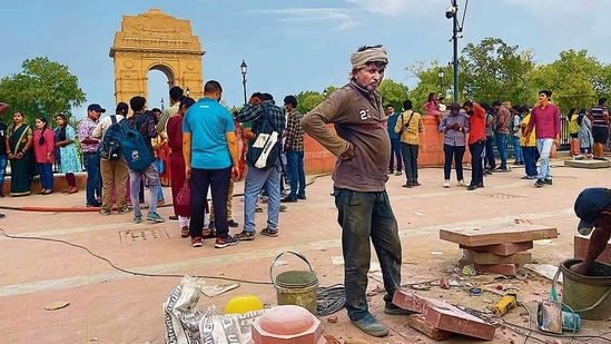 Due to the ongoing construction, it is not possible to go near India Gate, but crowds gaze upon it from a distance.