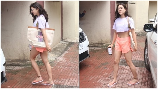 Sara's workout look features a lavender crop top with a 'No Photo' slogan on the front, a round neckline, droopy half-length sleeves, a cropped hem flaunting the star's toned midriff, and a loose silhouette. She wore it over a grey sports bra.(HT Photo/Varinder Chawla)
