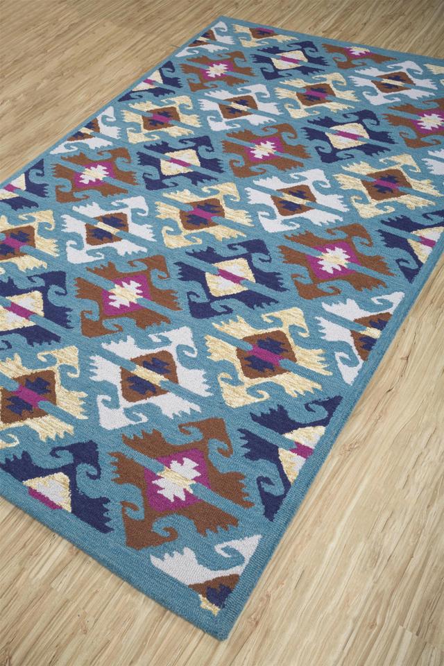 Rich vibrant colours and prints on a rug will add character and make your man den more vibrant and appealing. (Geometric print, multicoloured, handwoven rug by Jaipur Rugs