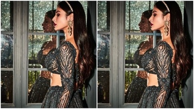 Mouni teamed an embellished teal blouse with a plunging neckline and dramatic sleeves with a long flowy teal skirt embroidered in silver resham threads. (Instagram/@imouniroy)