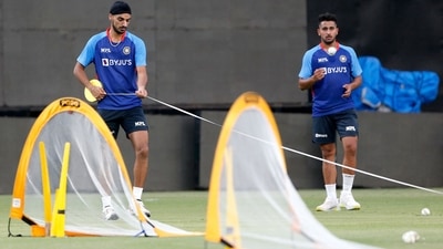 Arshdeep Singh (L) and Umran Malik attend a practice session at the Arun Jaitley Stadium in New Delhi (AFP)