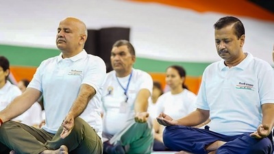 Delhi Chief Minister Arvind Kejriwal along with Dy CM Manish Sisodia and others performs yoga at the Thyagaraj Stadium to celebrate the International Day of Yoga, in New Delhi, Tuesday, (PTI) Delhi Chief Minister Arvind Kejriwal along with Dy CM Manish Sisodia and others performs yoga at the Thyagaraj Stadium to celebrate the International Day of Yoga, in New Delhi, Tuesday, (PTI)
