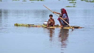 A woman with children rows a raft made from banana trees toward a safer area from the flooded village of Tarabari, in the northeastern Indian state of Assam. (AP Photo/Anupam Nath) (AP) A woman with children rows a raft made from banana trees toward a safer area from the flooded village of Tarabari, in the northeastern Indian state of Assam. (AP Photo/Anupam Nath) (AP)