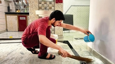 Nameer Alvi helps his mother clean their house in Old Delhi’s Pahari Rajaan. (HT Photo)