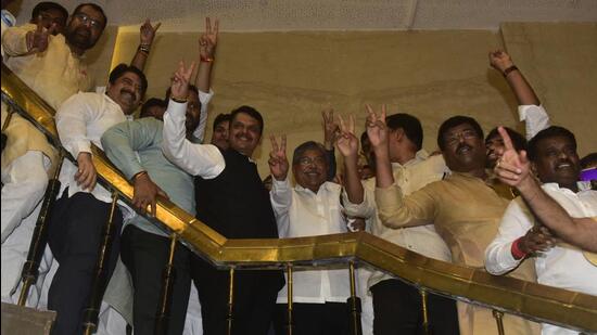 BJP leader Devendra Fadnavis along with BJP party MLAs celebrate after winning all 5 seat in MLC election at Vidhan Bhavan in Mumbai on Monday. (HT photo)
