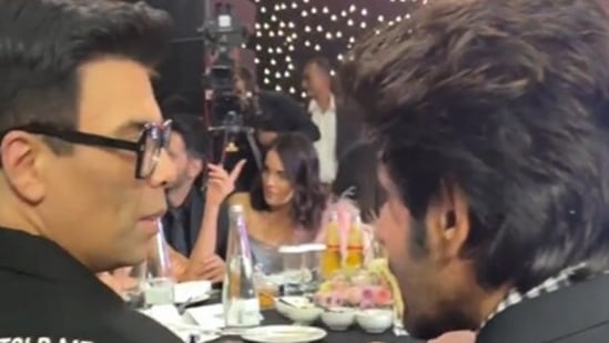 Karan Johar and Kartik Aaryan at a recent awards event, where they sat at the same table.&nbsp;