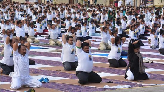 Tricity residents performed yoga as part International Yoga Day celebrations across tricity. (Sant Arora/HT )