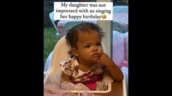 The image, taken from the viral Instagram video, shows the kid's unimpressed reaction to her family singing happy birthday.(Instagram/@mariamanna_)