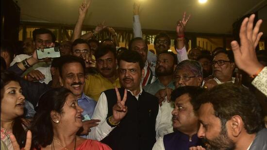 Devendra Fadnavis and other BJP lawmakers celebrate after winning five seat in legislative council elections on Monday. (HT PHOTO)