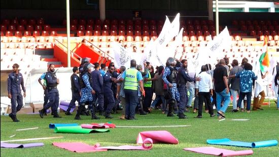 Police officers intervene as protesters disrupt an event celebrating International Day of Yoga organised at a stadium in Male, Maldives (via REUTERS)