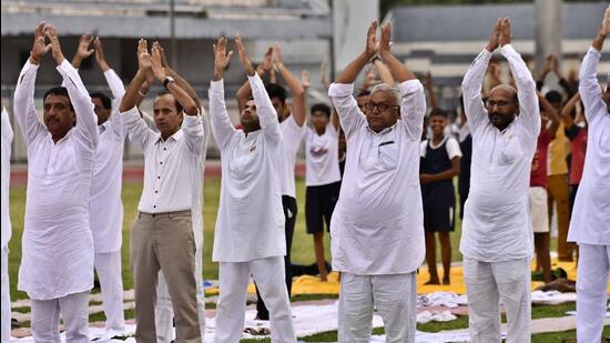 Ludhiana residents performing yoga on 8th International Yoga Day at Guru Nanak Stadium here. (Gurpreet Singh/HT)