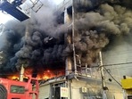 Flames and smoke from a fire in a building near Mundka metro station, in New Delhi. Flames and smoke from a fire in a building near Mundka metro station, in New Delhi. 
