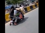 A screengrab of the video of a man riding an immensely overloaded scooter. (@TelanganaCOPs/Twitter) A screengrab of the video of a man riding an immensely overloaded scooter. (@TelanganaCOPs/Twitter)