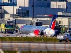 Firefighting units are seen next to a Red Air plane that caught fire after the front landing gear collapsed upon landing at Miami International Airport in Miami, after arriving from Santo Domingo, Dominican Republic, Tuesday, June 21, 2022. (Pedro Portal/Miami Herald via AP) Firefighting units are seen next to a Red Air plane that caught fire after the front landing gear collapsed upon landing at Miami International Airport in Miami, after arriving from Santo Domingo, Dominican Republic, Tuesday, June 21, 2022. (Pedro Portal/Miami Herald via AP)