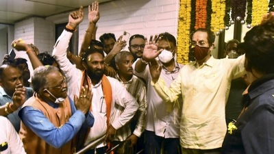 Maharashtra CM Uddhav Thackeray greets supporters gathered outside his official residence 'Varsha', before leaving for his personal residence 'Matoshree', in Mumbai, Wednesday. (PTI) Maharashtra CM Uddhav Thackeray greets supporters gathered outside his official residence 'Varsha', before leaving for his personal residence 'Matoshree', in Mumbai, Wednesday. (PTI)