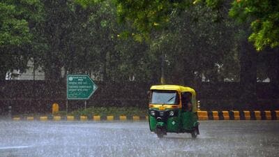 An auto rides through heavy rainfall in New Delhi on Tuesday. (ANI Photo)