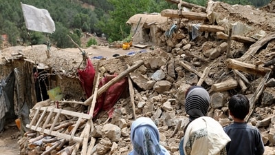 Afghan children stand near a house that was destroyed in an earthquake in the Spera district of the southwestern part of Khost Province, Afghanistan. (AP)