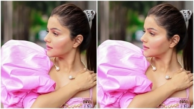 Rubina paired a pink slip-in cropped top with intricate mirror work in silver and golden and a dramatic pink sleeve in one arm with a pair of pink satin trousers with wide legs. (Instagram/@rubinadilaik)