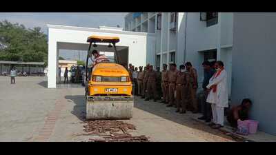 A bulldozer being used to crush illegal weapons in Kaushambi on Wednesday. (HT photo)