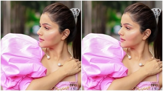 Rubina paired a pink slip-in cropped top with intricate mirror work in silver and golden and a dramatic pink sleeve in one arm with a pair of pink satin trousers with wide legs.(Instagram/@rubinadilaik)