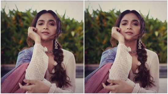 Keerthy decked up in a white dress intricately decorated in golden beads and a pink border at the ankles. She further layered her look with a pastel blue and a pink and white striped dupatta.(Instagram/@keerthysureshofficial)