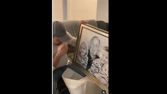 A screengrab of the video of a man who got emotional on seeing his late father's portrait along with his grandkids. (paintyourlife/Instagram)