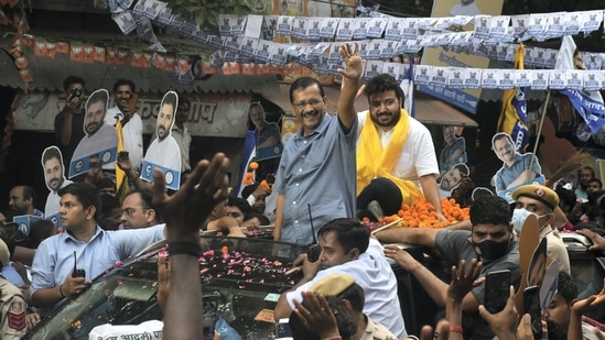 Delhi Chief Minister and AAP Convener Arvind Kejriwal waves at the supporters during a roadshow for Rajinder Nagar assembly constituency by-elections, at Inder Puri in New Delhi.(PTI)