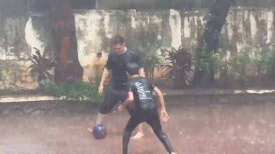 Aamir Khan and Azad Rao playing football amid heavy downpours in Mumbai. Aamir Khan and Azad Rao playing football amid heavy downpours in Mumbai.