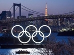 A boat sails past the Tokyo 2020 Olympic Rings