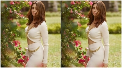 Aamna teamed a cropped white sweater with full sleeves and a plunging neckline with a high-waisted pencil skirt with one thigh high slit. The skirt featured golden chain details in one side. (Instagram/@aamnasharifofficial)