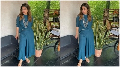 Raveena decked up in a blue satin top that featured elastic details near to the waist and came with long sleeves. Raveena teamed her top with a pair of blue coluttes with wide legs. (Instagram/@officialraveenatandon)