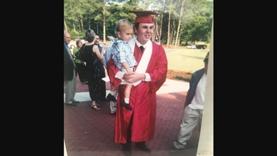 The image, taken from Reddit post, shows the dad with his son during his graduation ceremony. (Reddit/@bigK24)