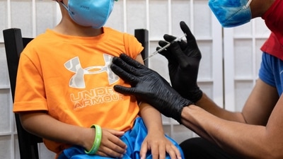 A child receives Covid vaccine dose.&nbsp; (REUTERS file image)