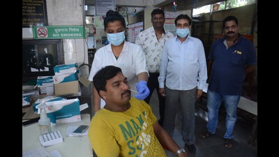 A health worker collects swab samples of a citizen for Covid-19 test at TMC's C.R. Wadia Hospital testing centre, in Thane, Mumbai on Thursday (Praful Gangurde/HT Photo) A health worker collects swab samples of a citizen for Covid-19 test at TMC's C.R. Wadia Hospital testing centre, in Thane, Mumbai on Thursday (Praful Gangurde/HT Photo)