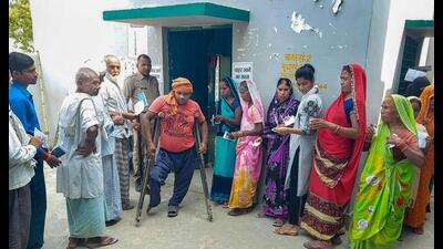 People wait in queue outside a polling station to cast their votes for Azamgarh Lok Sabha by-election, in Azamgarh, Thursday. (PTI Photo) People wait in queue outside a polling station to cast their votes for Azamgarh Lok Sabha by-election, in Azamgarh, Thursday. (PTI Photo)